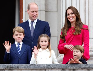 Prince George, Princess Charlotte and Prince Louis waving on the balcony at Buckingham Palace in front of Prince William and Princess Kate