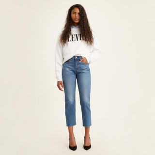 A model wearing Levi's wedgie jeans to illustrate a how to style jeans feature