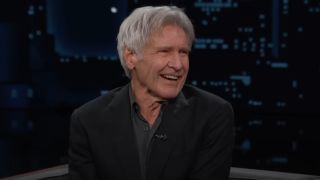 Harrison Ford smiling and looking to his right on Jimmy Kimmel.