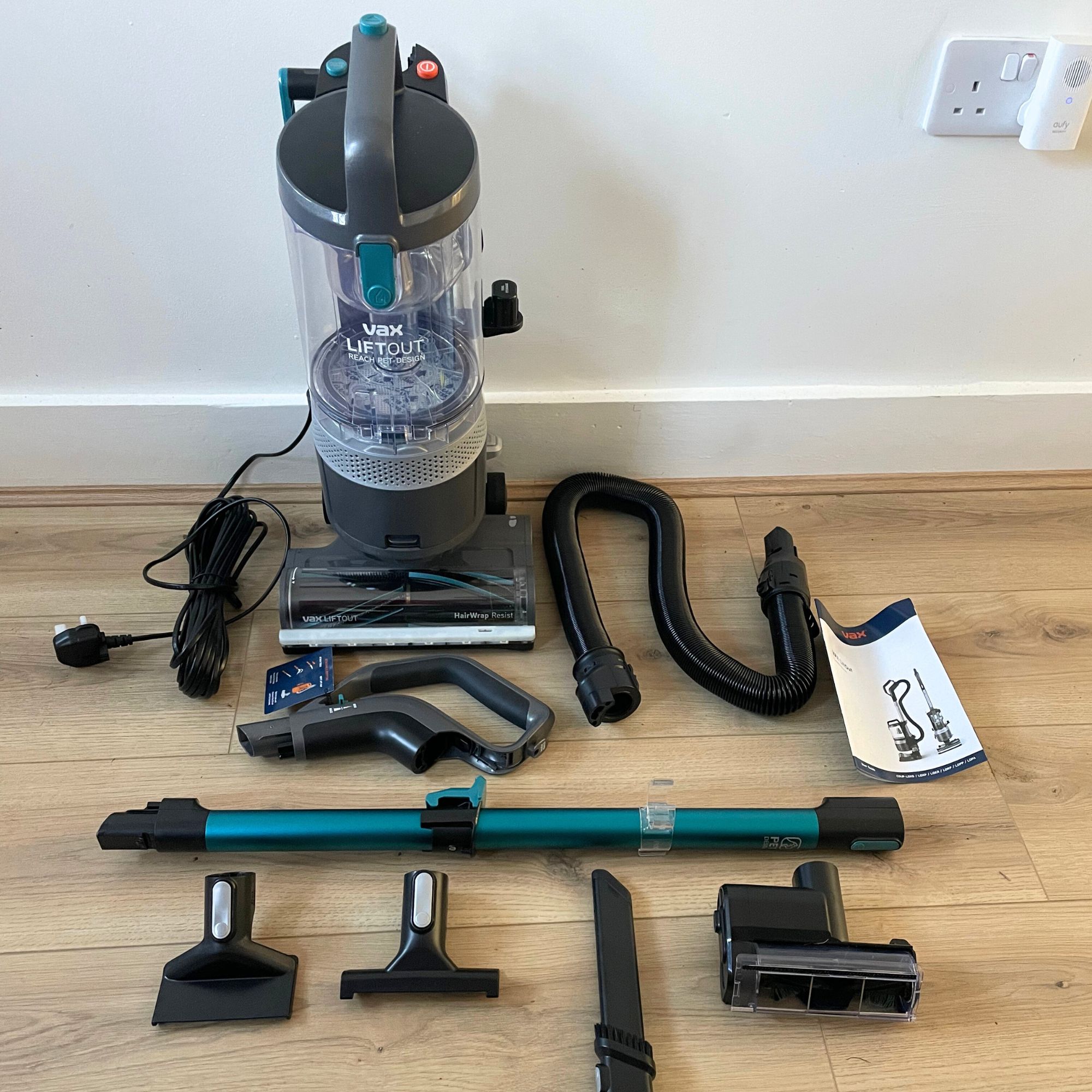 Vax LiftOut Reach Pet Design Vacuum Cleaner components laying out on wood effect flooring