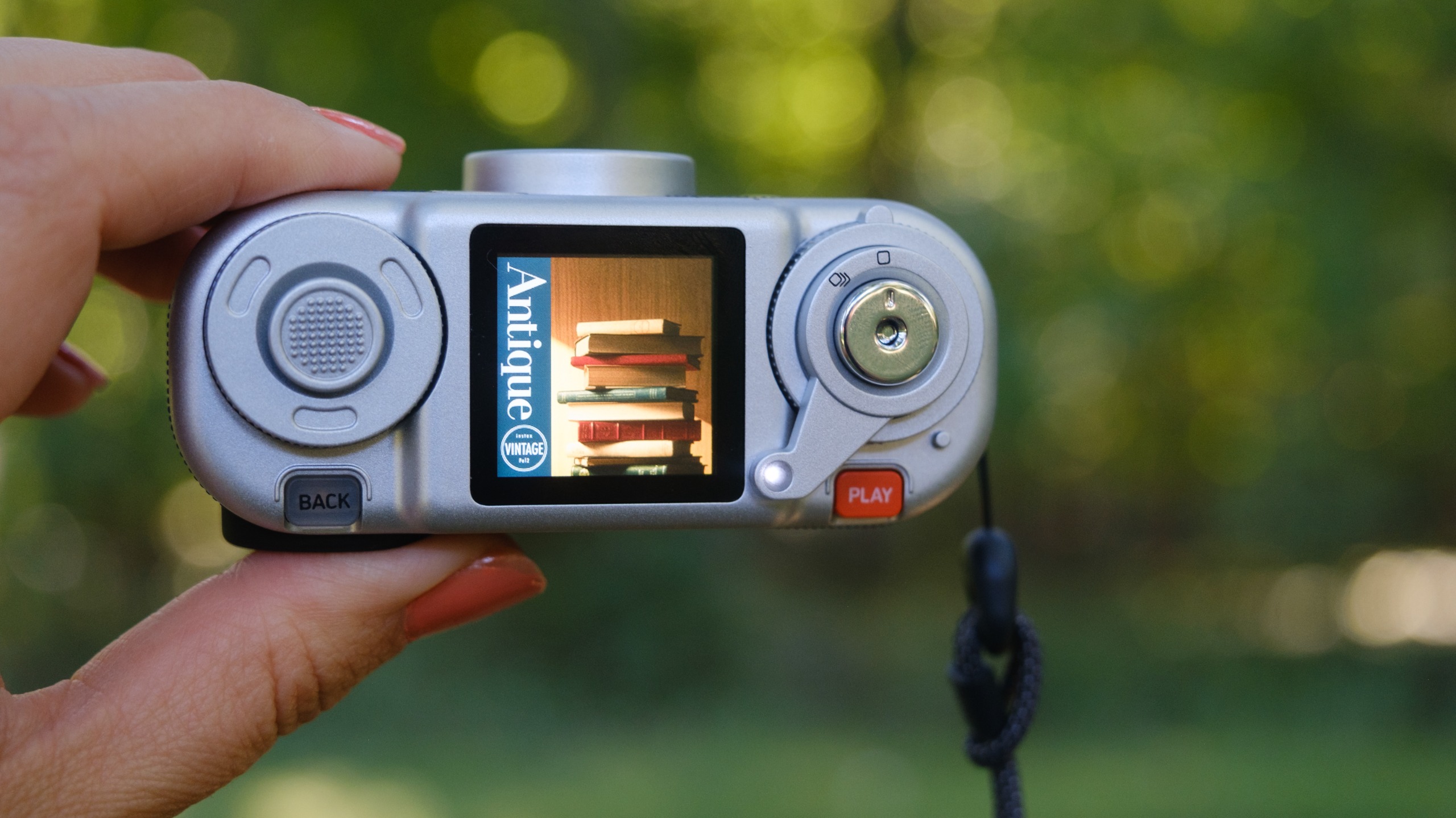 The Instax Pal 2 held in a photographer's hands