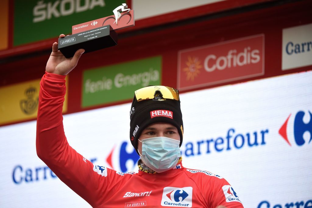 Team Jumbo rider Slovenias Primoz Roglic celebrates on the podium retaining the overall leaders red jersey after the 14th stage of the 2020 La Vuelta cycling tour of Spain a 2047km race from Lugo to Ourense on November 4 2020 Photo by MIGUEL RIOPA AFP Photo by MIGUEL RIOPAAFP via Getty Images