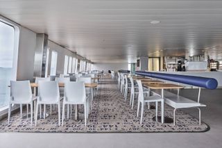 Tables and chairs inside MV Queenscliff Ferry by Lucy Marczyk Design Studio