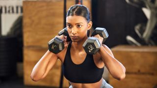 a photo of a woman holding two dumbbells