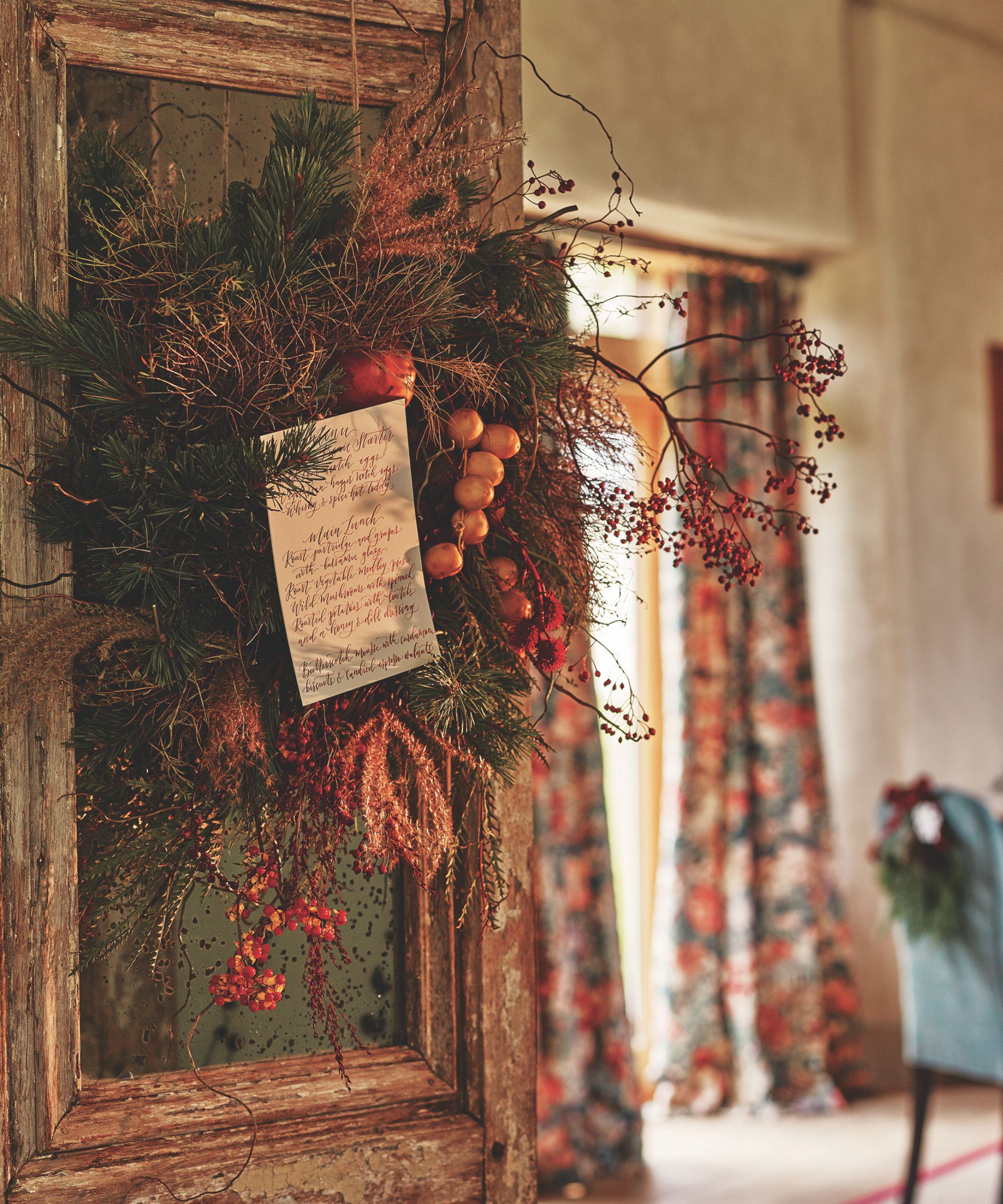 Fall wreath with handwritten menu pinned in the center