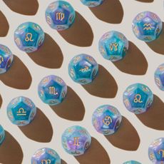 Zodiac dice laid out for an article about Lucky Girl trend