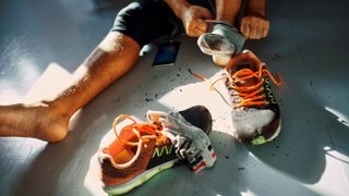 Close up of a man taking of his dirty shoes after a workout
