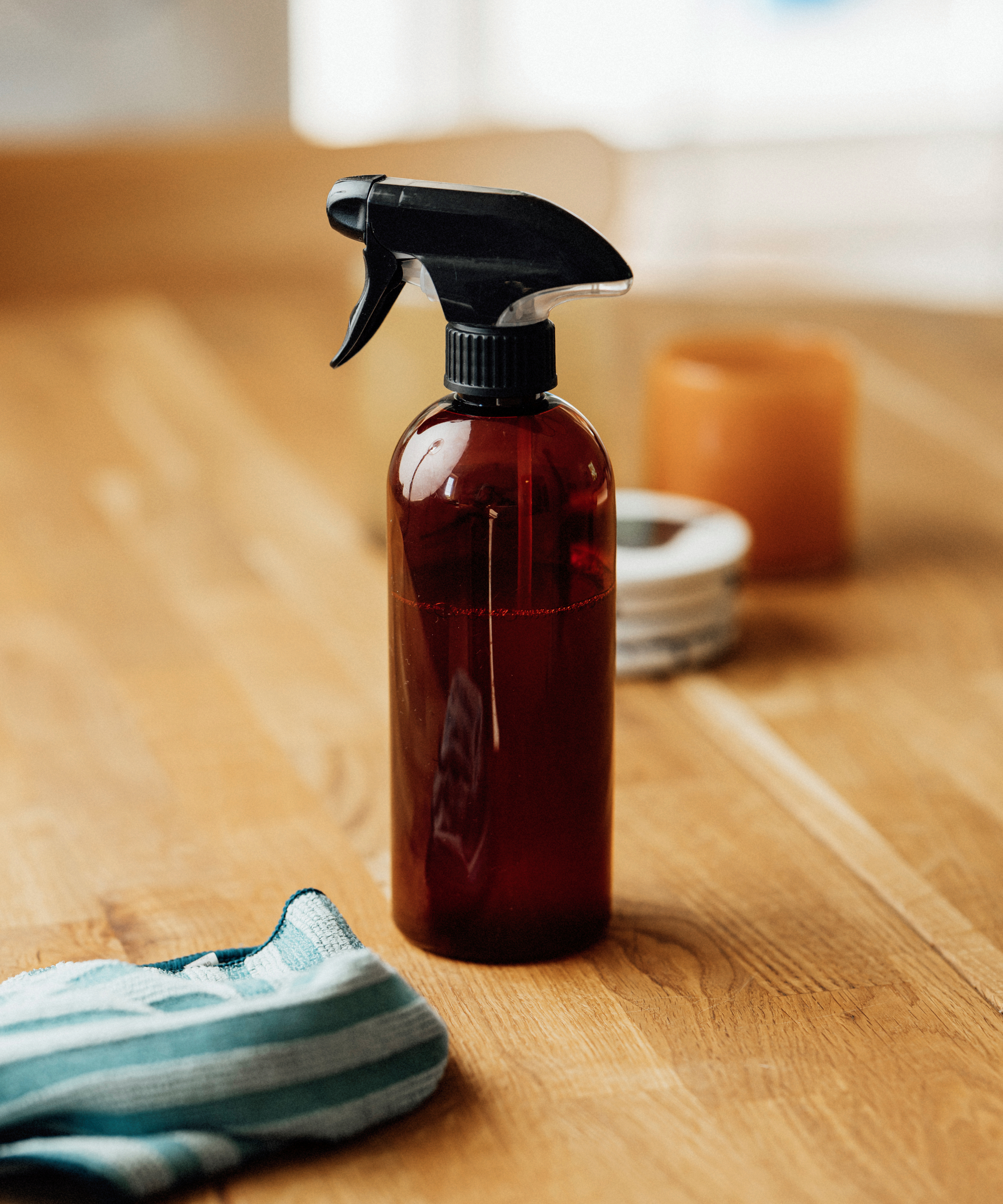 Amber glass spray bottle on table