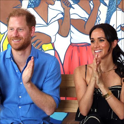 Prince Harry and Meghan Markle clap and laugh while visiting the Escuela Tambores de Cabildo in Cartagena, Colombia