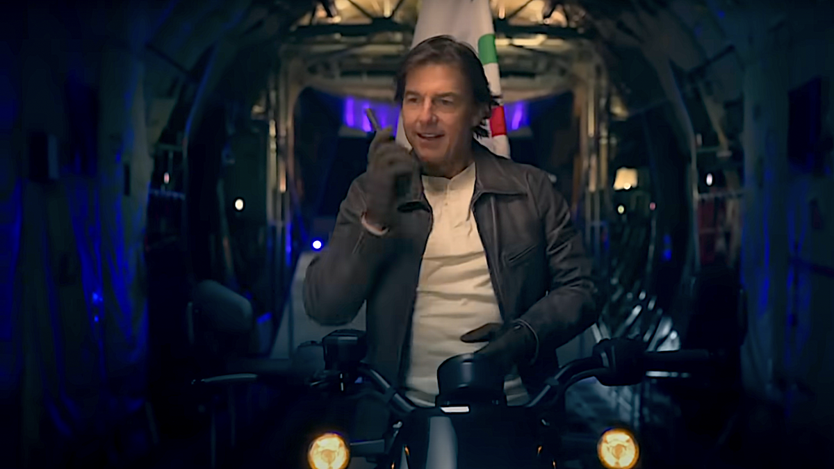 Tom Cruise riding motorcycle on a plane with Olympics flag during 2024 Paris Olympics Closing Ceremony