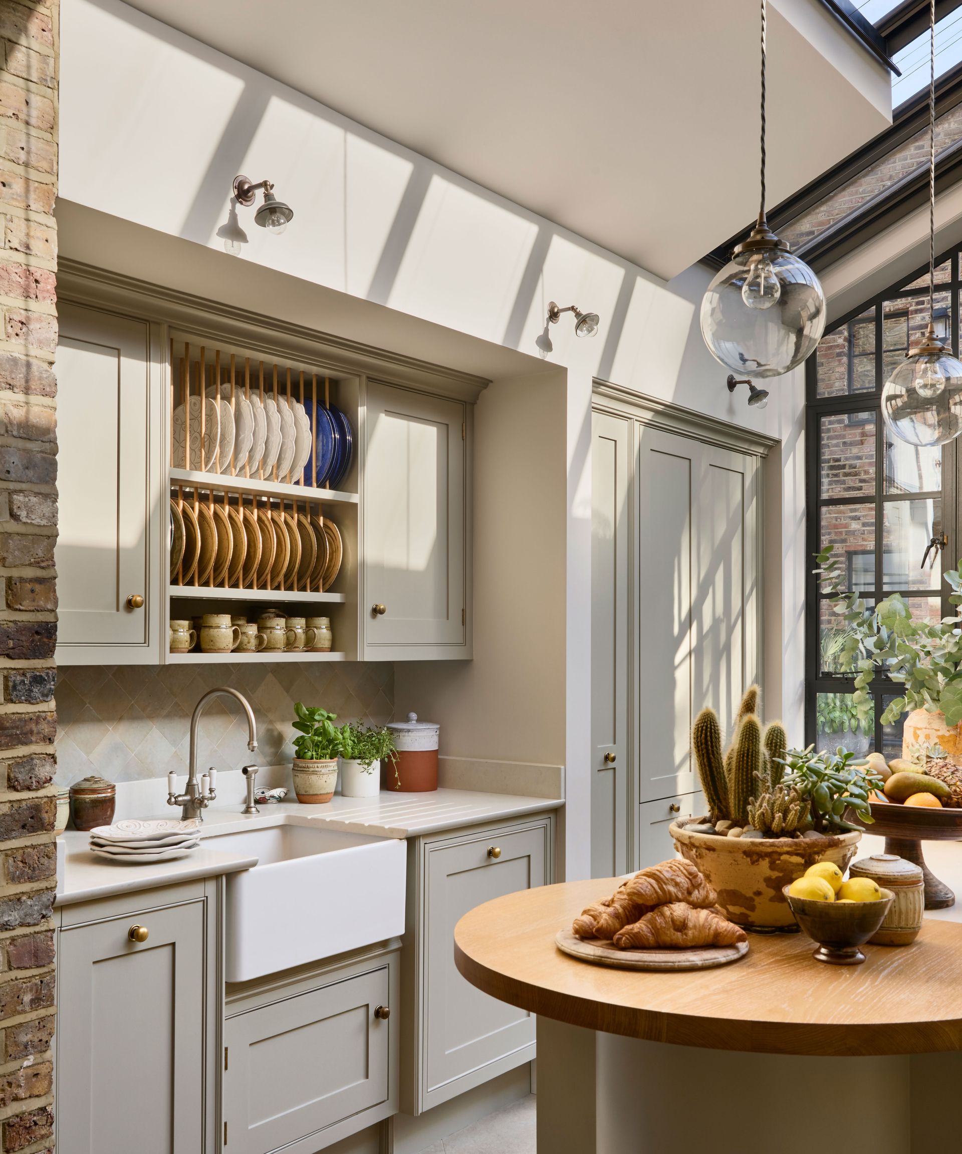 neutral colored kitchen with butler sink and plate rack over