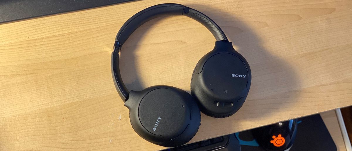 Sony WH-CH710N headphones on a wooden table