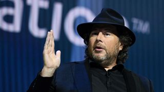 Marc Benioff wearing a hat and speaking at a live event