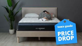 Helix mattress deals featuring one of our sleep editors on her side on the Helix Midnight Luxe Mattress