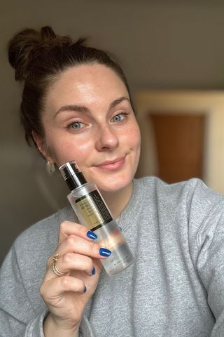 Tori holding the Cosrx Advanced Snail 96 Mucin Power Essence