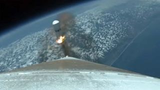 A strap-on rocket booster separates from ULA's Atlas V rocket during the SBIRS GEO Flight 5 satellite launch.