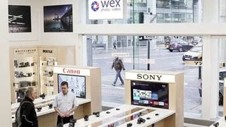 A Wex Photo Video store in London with customers wandering between aisles stocked with cameras and other tech