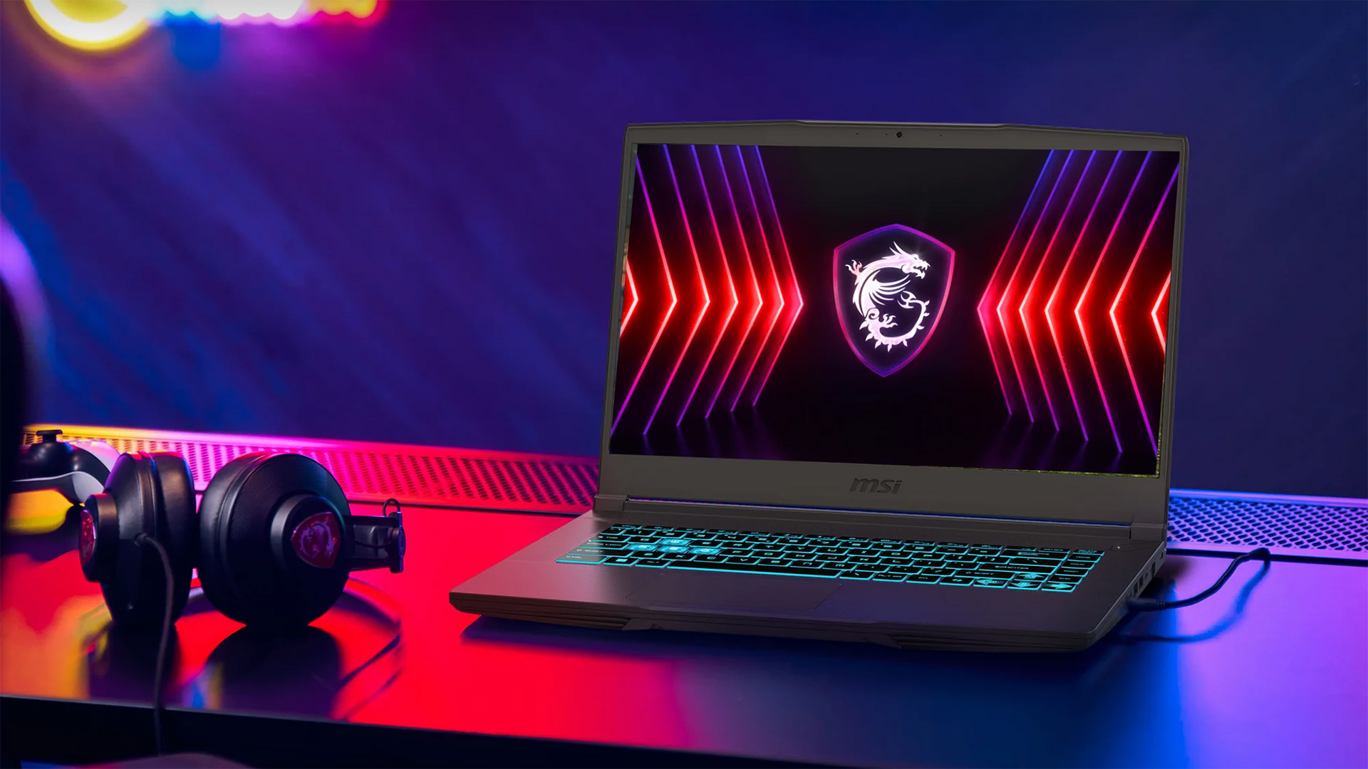 MSI Thin 15 (2025) promotional image of a gaming laptop on a desk with headphones