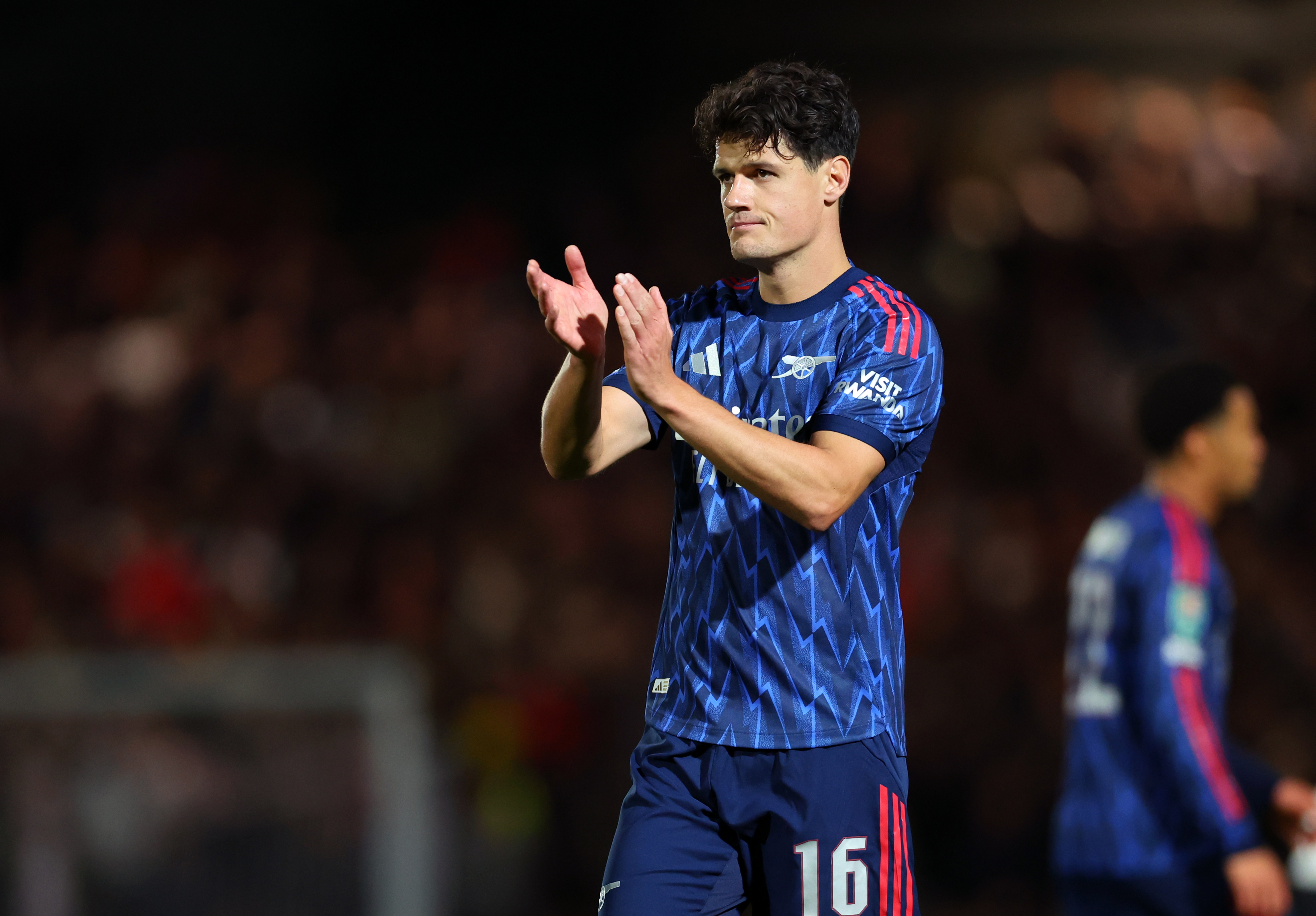 Arsenal midfielder Christian Norgaard applauds the fans