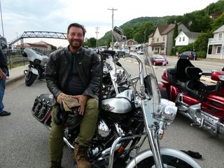 Nick Knowles sitting on a Harley Davidson.