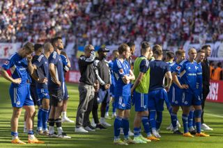 Schalke players acknowledge their fans after relegation from the Bundesliga following a game against RB Leipzig in May 2023.