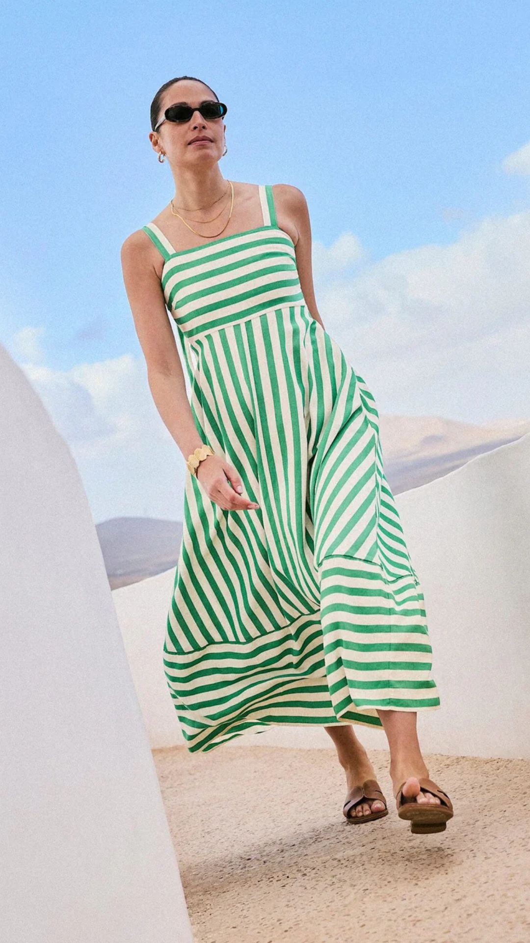a model wearing the mint velvet striped dress