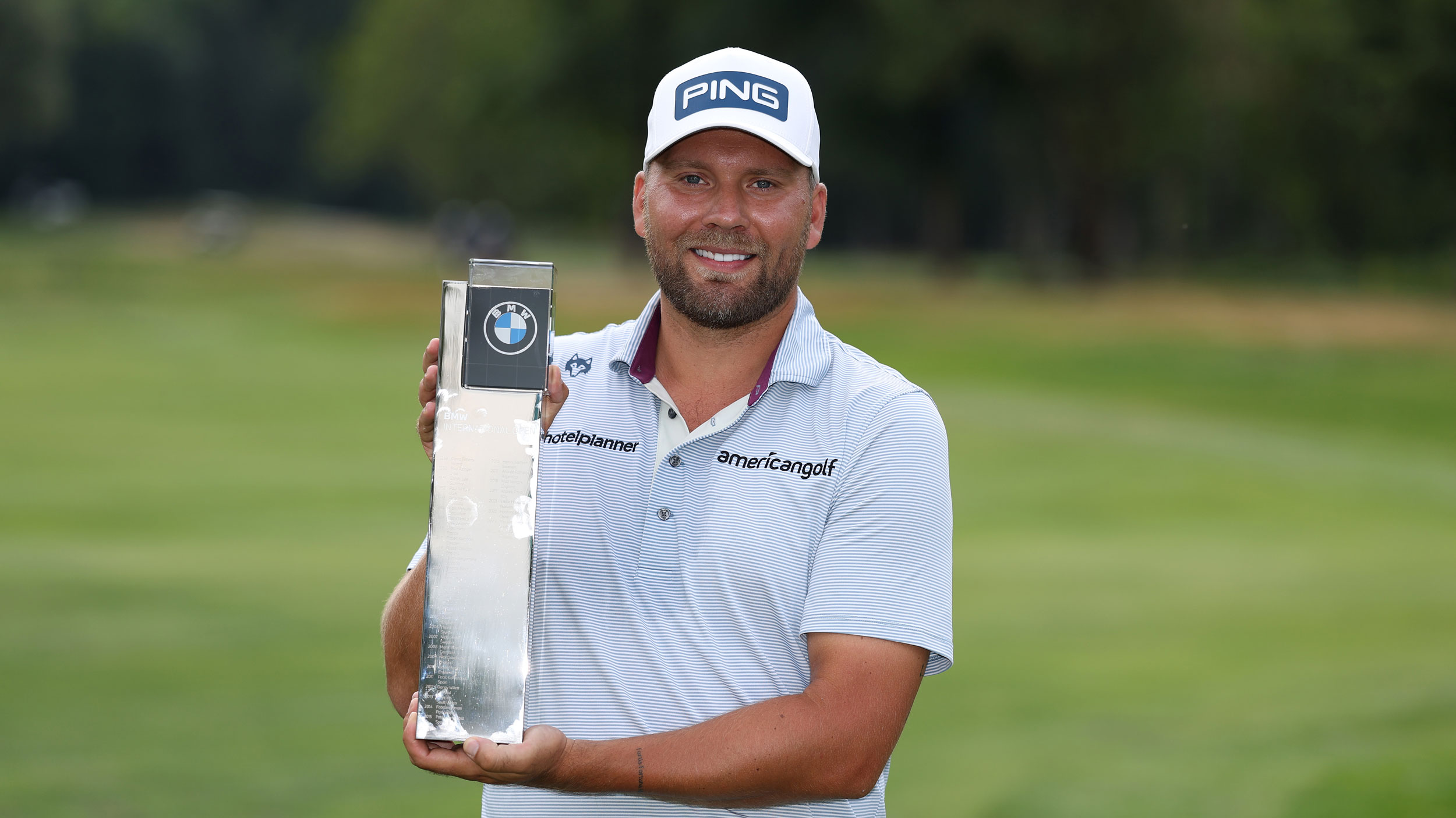 Dan Brown poses with the BMW International Open trophy after winning in 2025