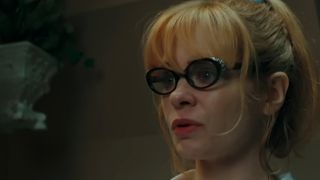 A close up of Adrienne Shelly wearing glasses in Waitress