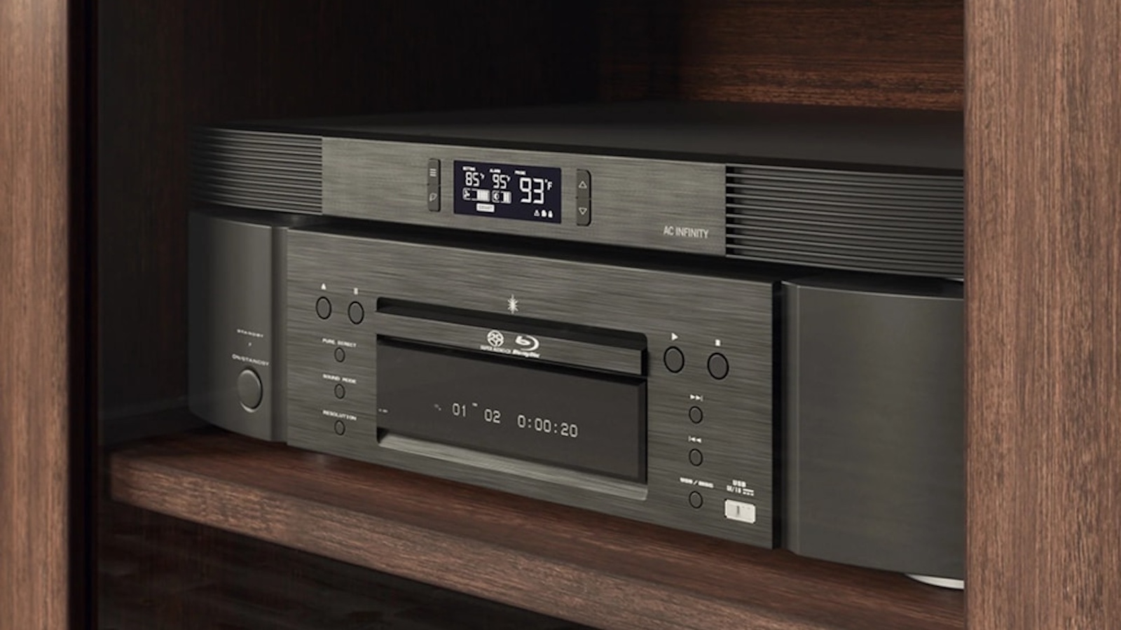 A photo of an AC Infinity T10 cooler placed atop a high-end Blu-ray player in a wooden cabinet.