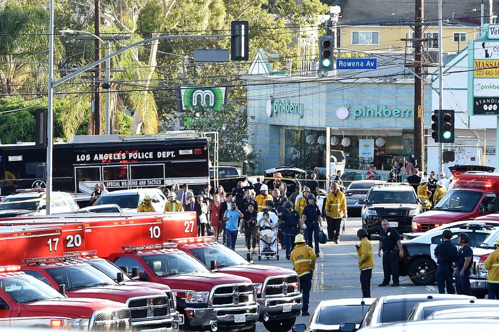 Police officers and members of the Los Angeles Fire Department escort a woman on a stretcher after a suspect barricaded inside a Trader Joe&amp;#039;s supermarket in Silverlake, Los Angeles, on July 2