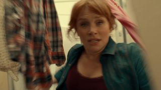 Bryce Dallas Howard running through a clothesline of laundry in Jurassic World Dominion.