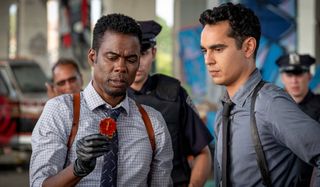 Chris Rock and Max Minghella examine a piece of evidence in Spiral: From the Book of Saw.