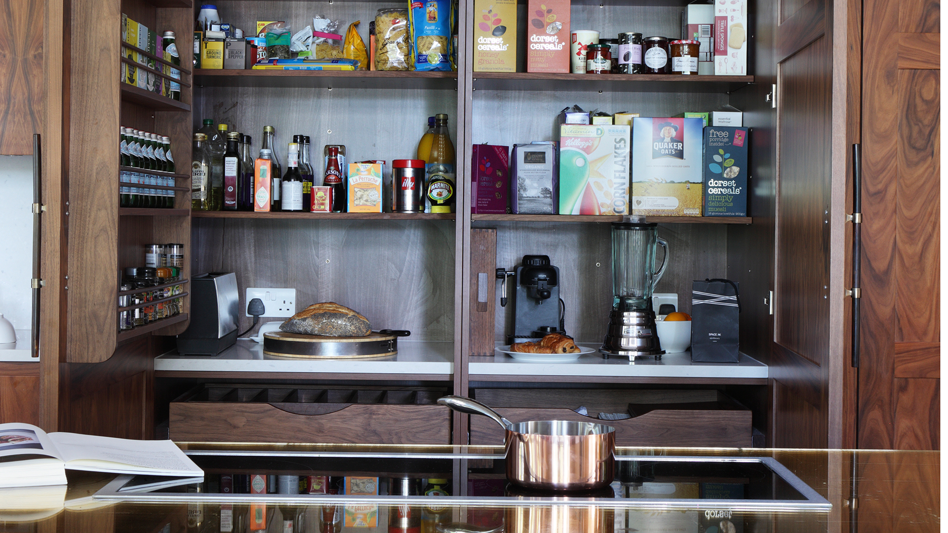 inside a kitchen pantry cupboard with appliances and food supplies