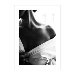 A black and white wall art print with a woman wearing a white shirt