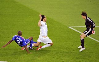 France defender Eric Abidal brings down Italy forward Luca Toni and is sent off in the teams' group game at Euro 2008.