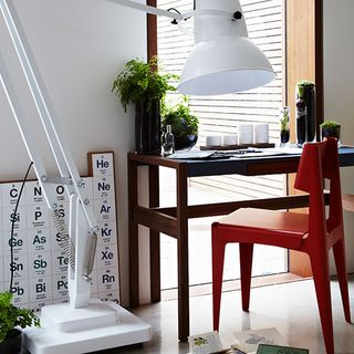 home office with white lamp and white wall and wooden desk and chair