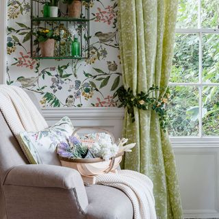 room with floral wallpaper and green curtains