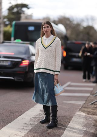 Veronika Heilbrunner seen wearing cream and black Lacoste sweater, white shirt, blue denim jeans skirt and black boots with tan and light blue bag outside Lacoste Show during the Womenswear Fall/Winter 2024/2025 as part of Paris Fashion Week on March 05, 2024 in Paris, France. (Photo by Jeremy Moeller/Getty Images)