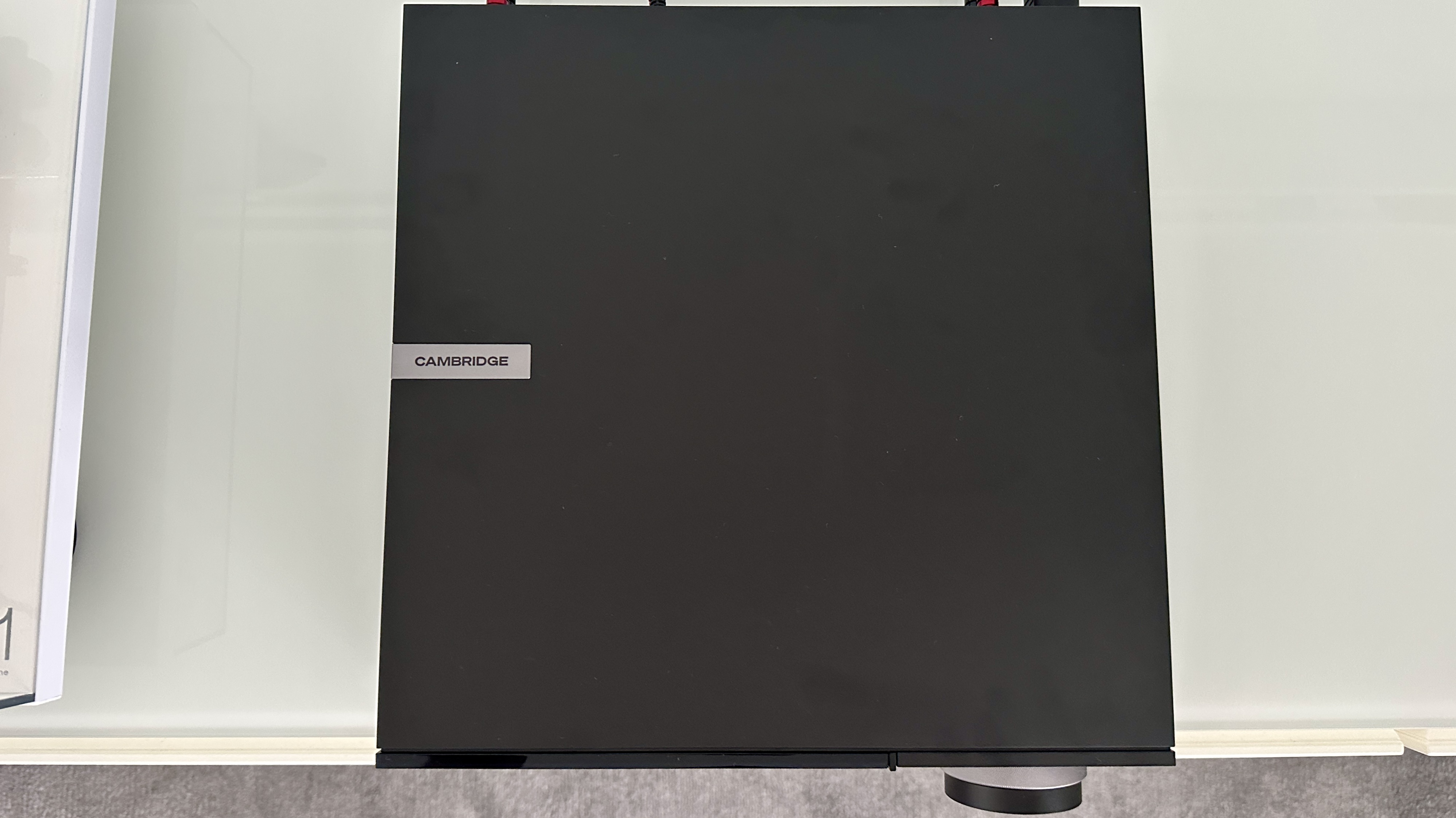 The Cambridge Evo 150 SE on a gray hi-fi rack, showing the color screen, grilles and ports