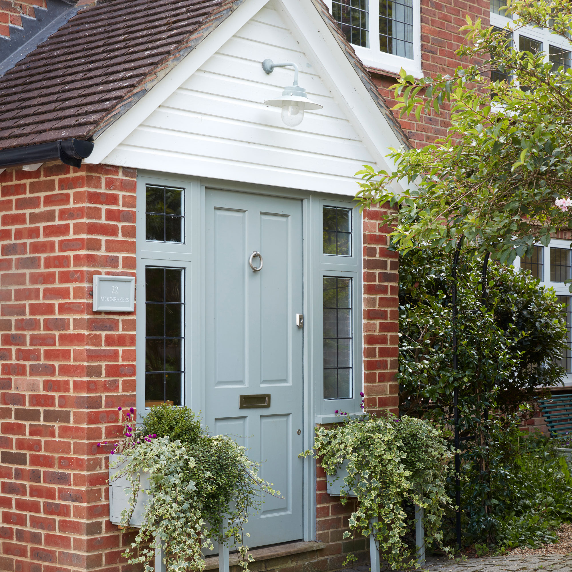 Red bright house with blue front door and pitched roof