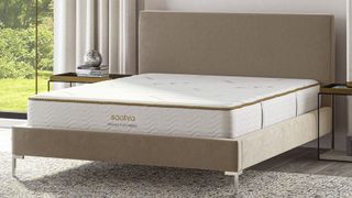 The Saatva Memory Foam Hybrid in a well-lit bedroom