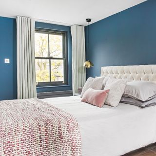 Blue bedroom with black painted sash windows