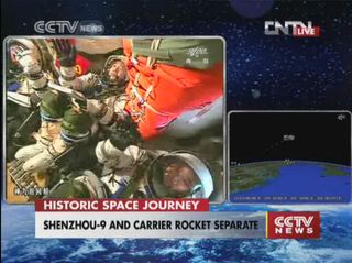 The three astronauts on China's Shenzhou 9 space capsule wave to cameras wearing broad smiles after reaching orbit on June 16, 2012, in this still from a CCTV broadcast.