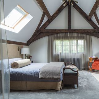 attic bedroom with windows and lamp