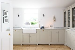 Bright white and cream calming kitchen with a candle on the counter