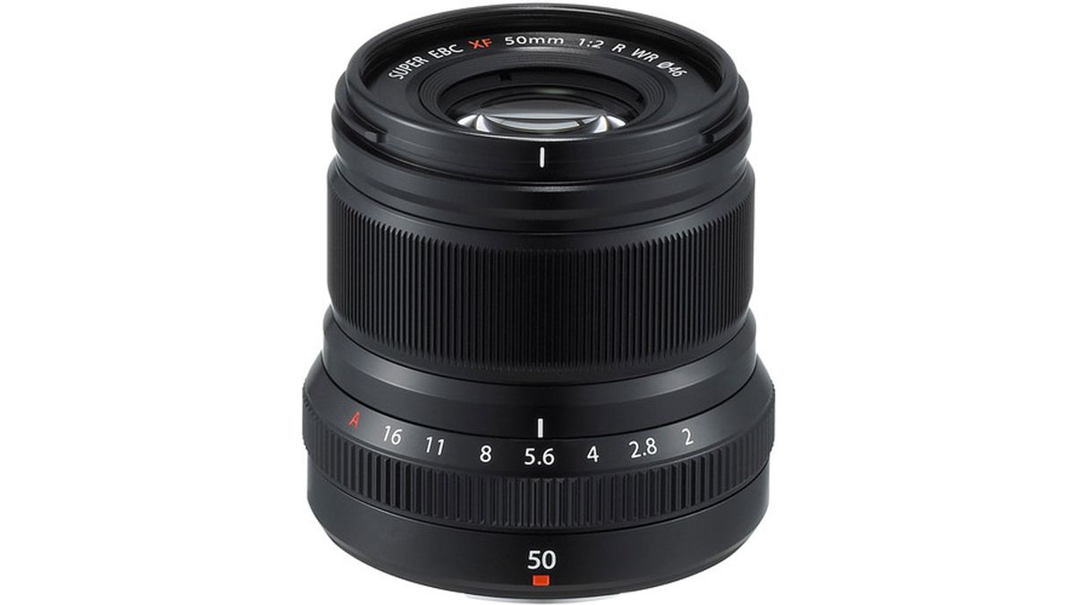 A black Fujifilm XF 50mm f/2 R WR lens standing upright and showing the front element