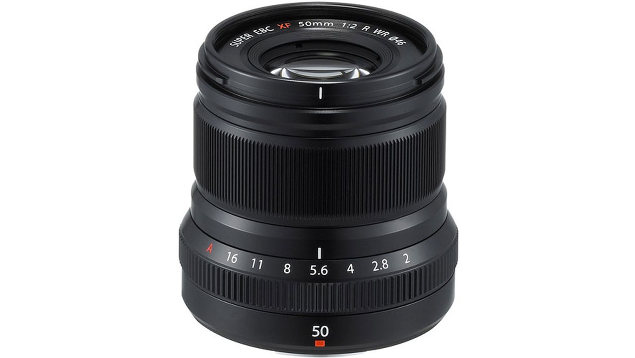 A black Fujifilm XF 50mm f/2 R WR lens standing upright and showing the front element