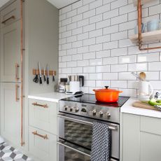 kitchen with white tiles and kitchen cabinet