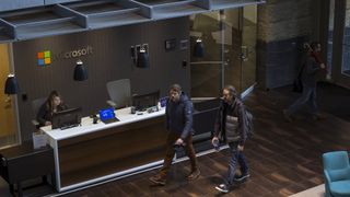 People enter the Studio B building of the Microsoft Corp. main campus in Redmond, Washington, U.S.