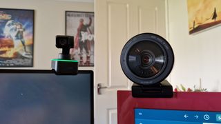 Insta360 Link sitting next to a Razer Kiyo Pro Ultra, showing the disparity in the form factors of the two